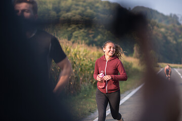 Image showing young people jogging on country road