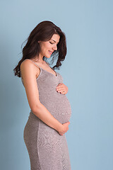 Image showing Portrait of pregnant woman over blue background