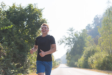 Image showing man jogging along a country road