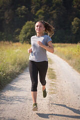 Image showing woman jogging along a country road