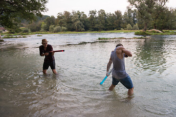 Image showing young men having fun with water guns