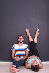 Image showing pregnant couple relaxing on the floor