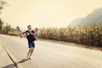 Image showing happy couple jogging along a country road