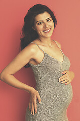 Image showing Portrait of pregnant woman over red background