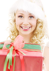 Image showing cheerful santa helper girl with gift box