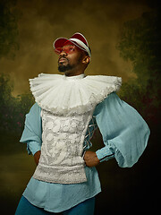 Image showing Young man as a medieval knight on dark background