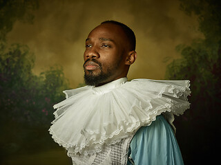 Image showing Young man as a medieval knight on dark background