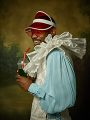 Image showing Young man as a medieval knight on dark background