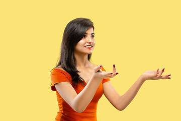 Image showing Portrait of beautiful woman isolated on yellow studio background