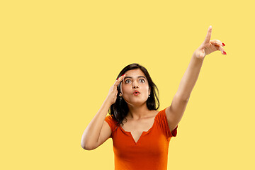 Image showing Portrait of beautiful woman isolated on yellow studio background