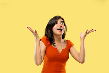 Image showing Portrait of beautiful woman isolated on yellow studio background