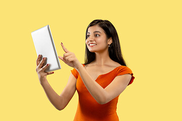 Image showing Portrait of beautiful woman isolated on yellow studio background