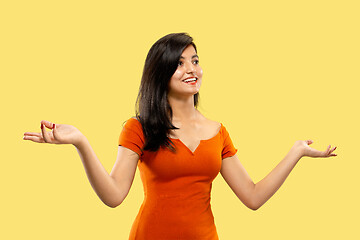 Image showing Portrait of beautiful woman isolated on yellow studio background