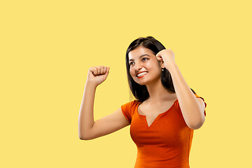 Image showing Portrait of beautiful woman isolated on yellow studio background