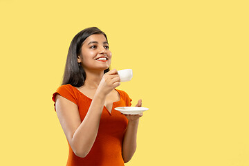 Image showing Portrait of beautiful woman isolated on yellow studio background