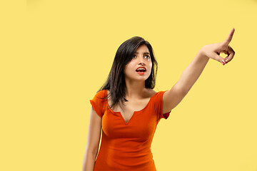 Image showing Portrait of beautiful woman isolated on yellow studio background