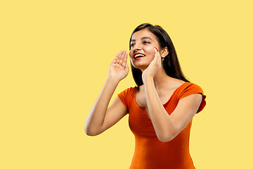 Image showing Portrait of beautiful woman isolated on yellow studio background