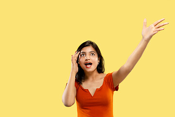 Image showing Portrait of beautiful woman isolated on yellow studio background