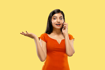 Image showing Portrait of beautiful woman isolated on yellow studio background