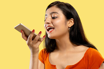 Image showing Portrait of beautiful woman isolated on yellow studio background