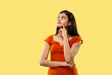 Image showing Portrait of beautiful woman isolated on yellow studio background