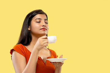 Image showing Portrait of beautiful woman isolated on yellow studio background