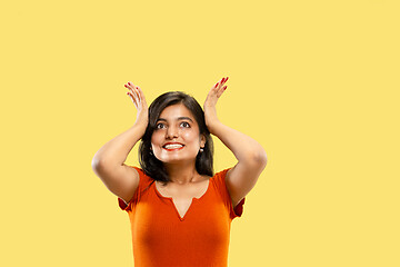 Image showing Portrait of beautiful woman isolated on yellow studio background