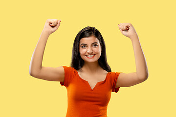 Image showing Portrait of beautiful woman isolated on yellow studio background