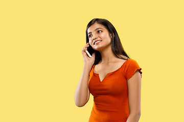 Image showing Portrait of beautiful woman isolated on yellow studio background