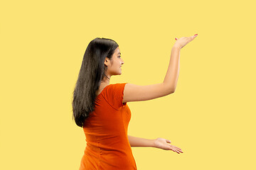 Image showing Portrait of beautiful woman isolated on yellow studio background