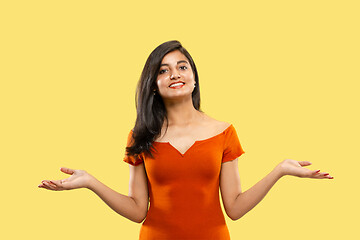 Image showing Portrait of beautiful woman isolated on yellow studio background