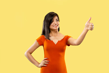 Image showing Portrait of beautiful woman isolated on yellow studio background