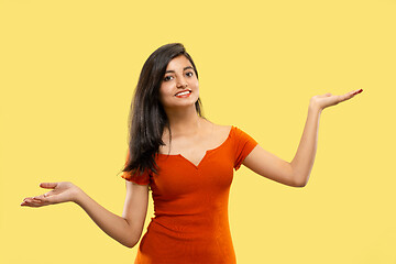 Image showing Portrait of beautiful woman isolated on yellow studio background