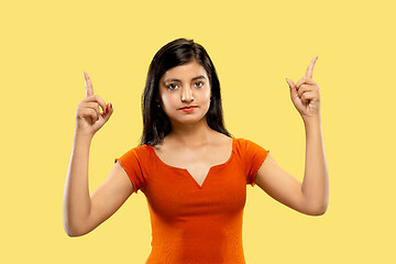 Image showing Portrait of beautiful woman isolated on yellow studio background