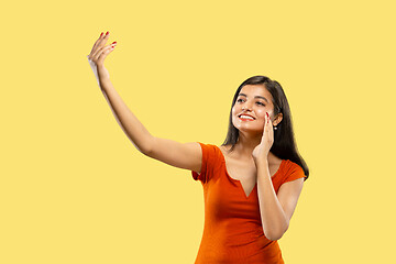 Image showing Portrait of beautiful woman isolated on yellow studio background