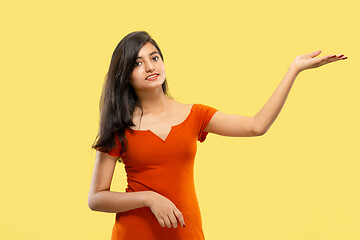 Image showing Portrait of beautiful woman isolated on yellow studio background