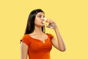 Image showing Portrait of beautiful woman isolated on yellow studio background