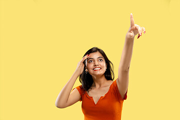 Image showing Portrait of beautiful woman isolated on yellow studio background