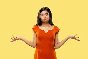 Image showing Portrait of beautiful woman isolated on yellow studio background