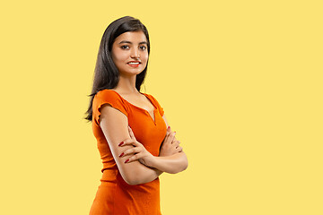 Image showing Portrait of beautiful woman isolated on yellow studio background