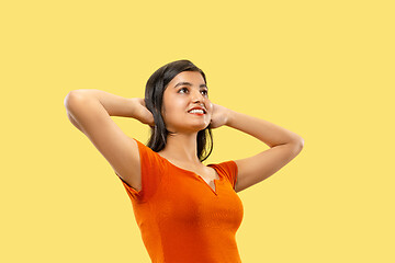 Image showing Portrait of beautiful woman isolated on yellow studio background