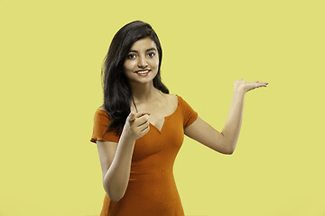 Image showing Portrait of beautiful woman isolated on yellow studio background