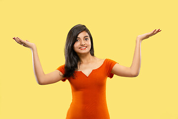 Image showing Portrait of beautiful woman isolated on yellow studio background