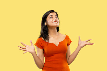 Image showing Portrait of beautiful woman isolated on yellow studio background