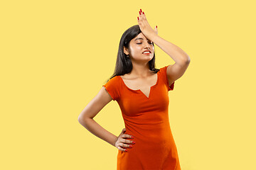 Image showing Portrait of beautiful woman isolated on yellow studio background