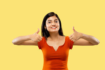 Image showing Portrait of beautiful woman isolated on yellow studio background