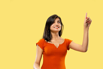 Image showing Portrait of beautiful woman isolated on yellow studio background