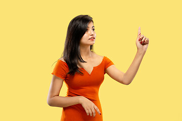 Image showing Portrait of beautiful woman isolated on yellow studio background