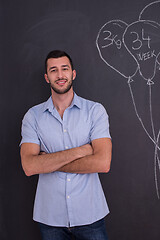 Image showing portrait of man in front of black chalkboard