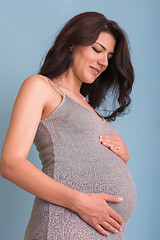 Image showing Portrait of pregnant woman over blue background